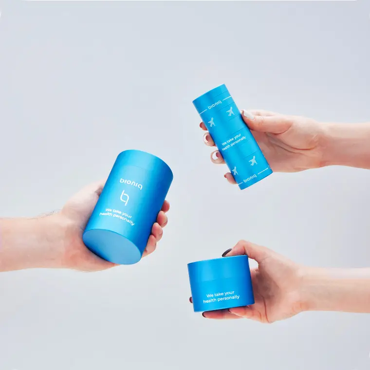 Three hands each holding a Bioniq container